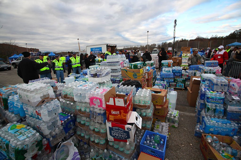 Staten Island - New York - USA - November 4 2012: National guard & Red Cross brought tons of supplies to New Dorp high school to aid hurricane Sandy victims. Piles of bottled water stacked for distribution
